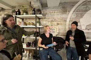 Tour guide explaining New York's history with coffee in a coffee shop
